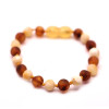 Baroka stila balta un konjaka krāsas nepulēta dzintara rokas - kājas sprādze mazuļiem